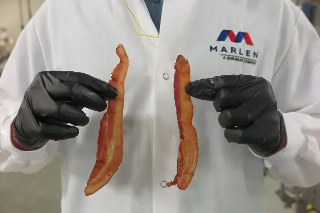 Marlen employee holding 2 bacon slices